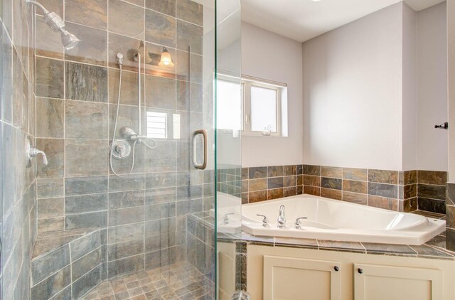 bathroom featuring shower with separate bathtub