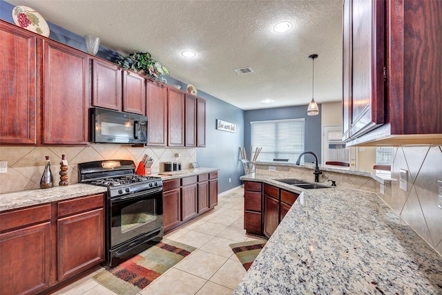 kitchen with black appliances, hanging light fixtures, sink, light stone countertops, and light tile patterned floors