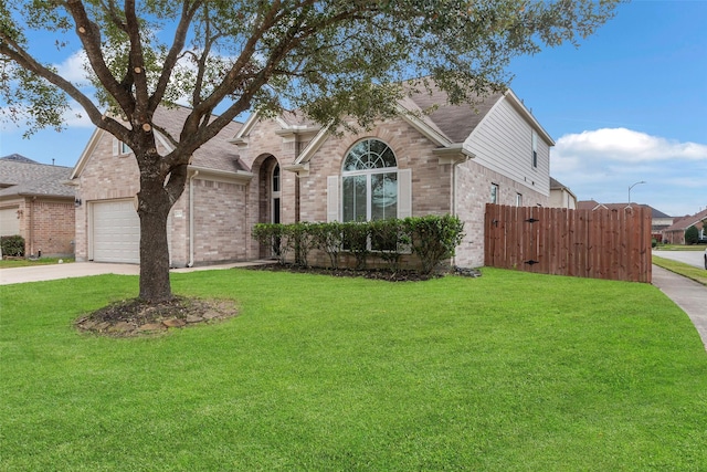 view of front of home with a garage and a front lawn