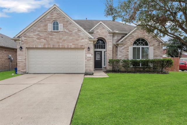 view of front of house featuring a front yard and a garage