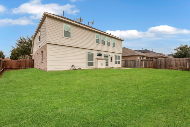 rear view of property with a yard