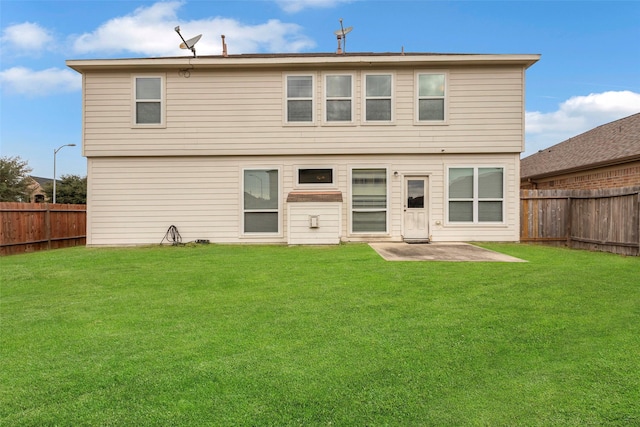 back of house featuring a lawn and a patio area