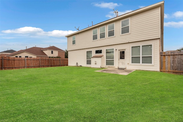 rear view of house featuring a patio and a lawn