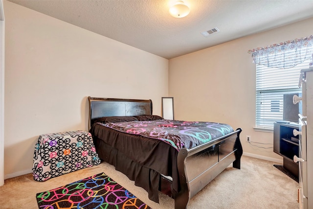 carpeted bedroom with a textured ceiling