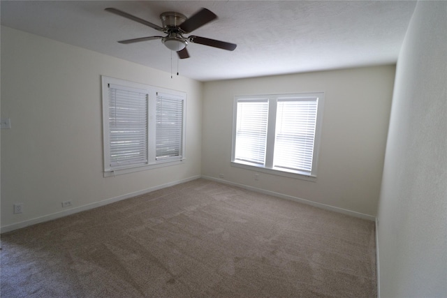 unfurnished room featuring light colored carpet and ceiling fan