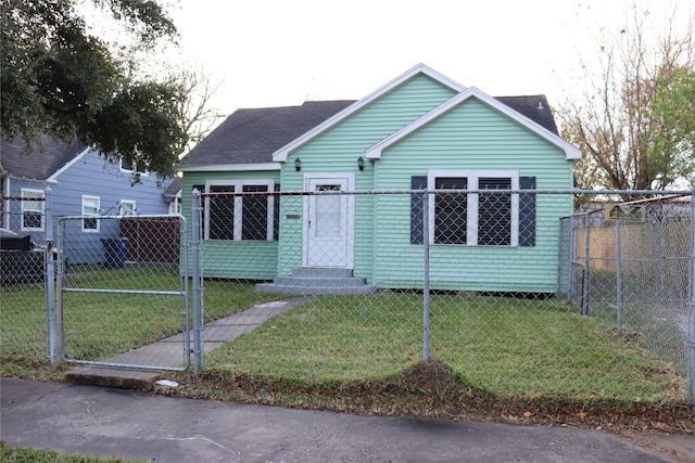 bungalow-style home featuring a front lawn