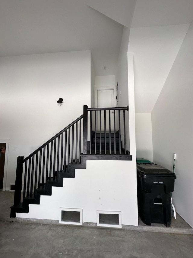 stairs featuring concrete floors