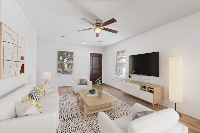 living room with hardwood / wood-style flooring and ceiling fan