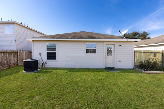 back of house with a yard and cooling unit