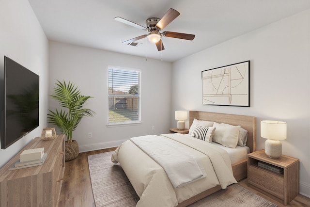 bedroom with ceiling fan and wood-type flooring