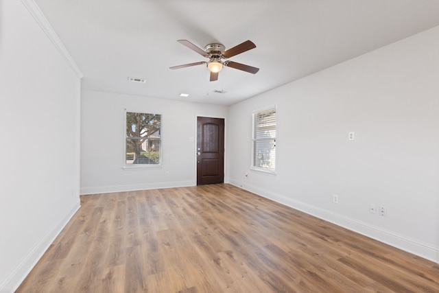 empty room with ceiling fan and light wood-type flooring