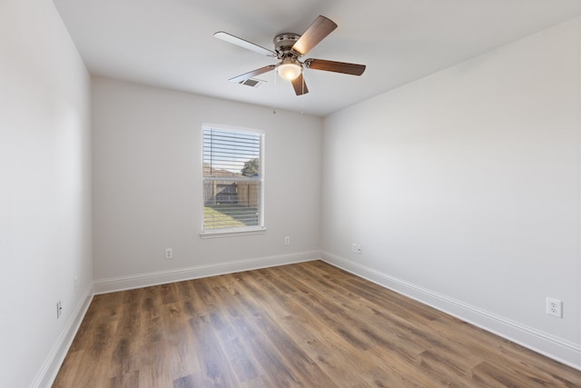 spare room featuring ceiling fan and dark hardwood / wood-style floors