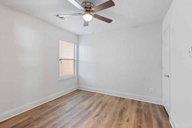 unfurnished room with ceiling fan and hardwood / wood-style floors