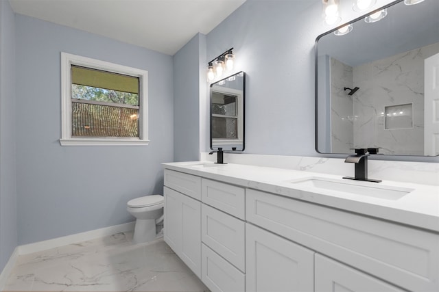 bathroom featuring tiled shower, vanity, and toilet