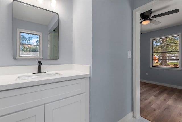 bathroom featuring hardwood / wood-style floors, vanity, and ceiling fan