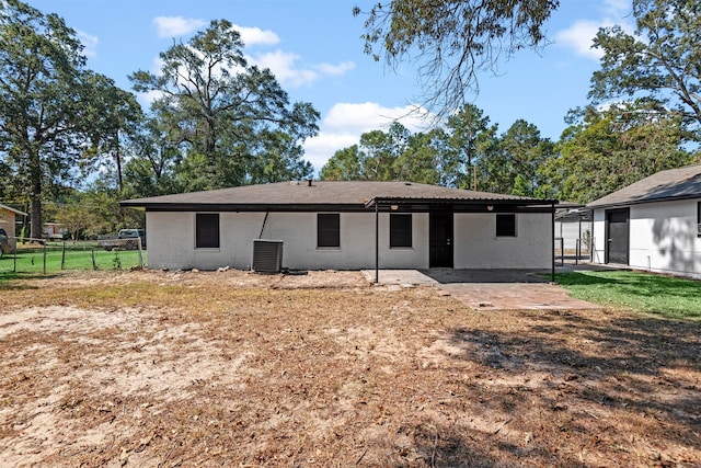 rear view of property featuring central AC unit and a patio area