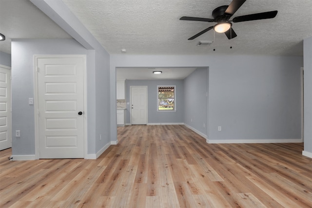 spare room featuring a textured ceiling, light hardwood / wood-style floors, and ceiling fan