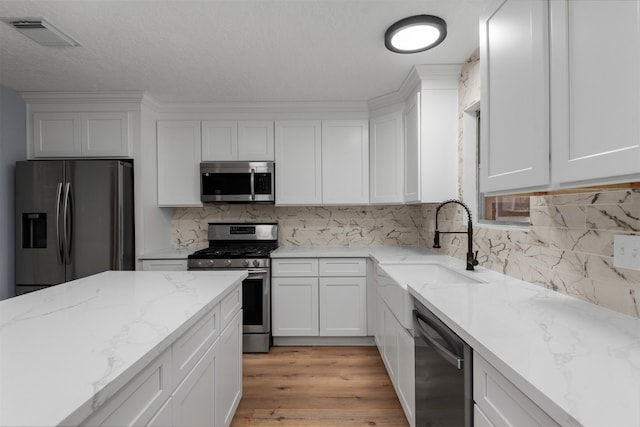 kitchen featuring white cabinets and appliances with stainless steel finishes