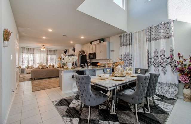 dining space featuring ceiling fan and light tile patterned flooring