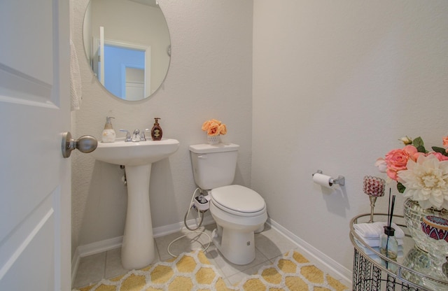 bathroom with tile patterned floors, sink, and toilet