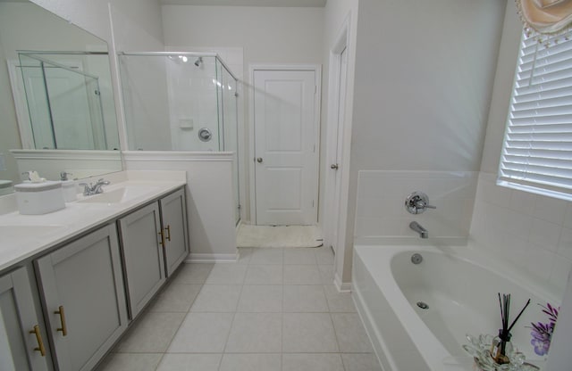 bathroom with tile patterned flooring, vanity, a healthy amount of sunlight, and separate shower and tub