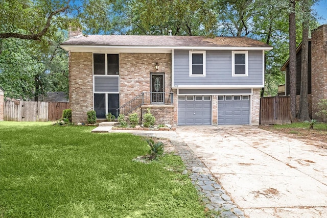 split foyer home with a front yard and a garage