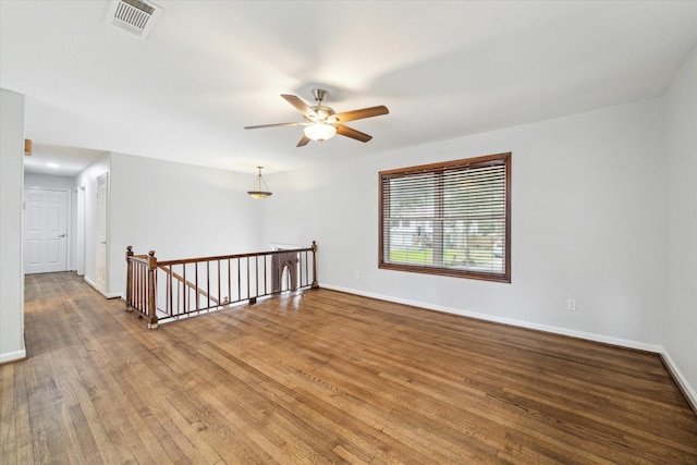 empty room featuring hardwood / wood-style floors and ceiling fan