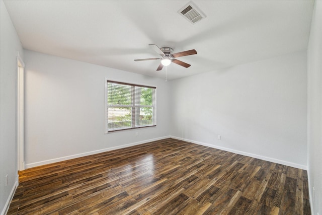 spare room featuring dark hardwood / wood-style flooring and ceiling fan