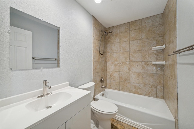 full bathroom with vanity, toilet, and tiled shower / bath