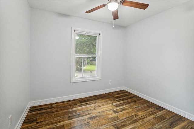 spare room featuring dark hardwood / wood-style flooring and ceiling fan