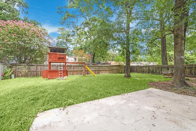 view of yard featuring a playground and a patio area