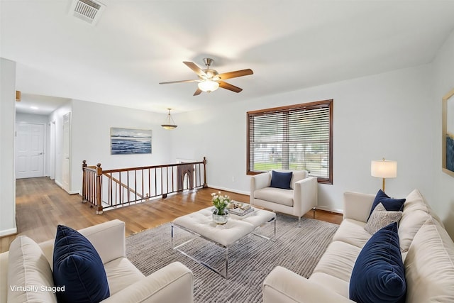 living room with ceiling fan and light wood-type flooring