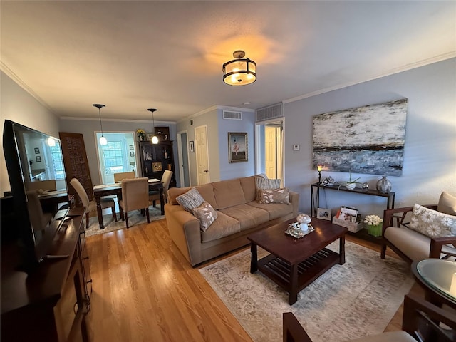 living room featuring light hardwood / wood-style floors and ornamental molding