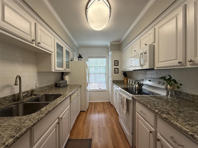 kitchen with backsplash, white cabinetry, sink, and white appliances