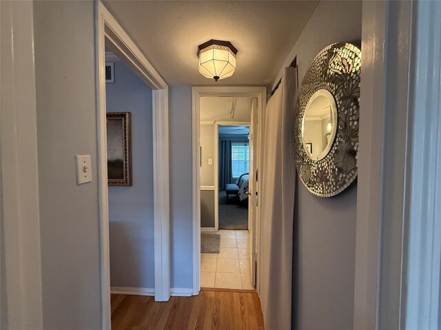 corridor featuring wood-type flooring