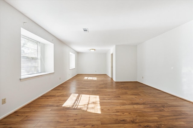 unfurnished room with hardwood / wood-style floors