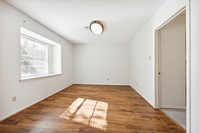 unfurnished room featuring hardwood / wood-style floors