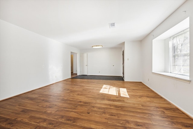 unfurnished room with hardwood / wood-style floors