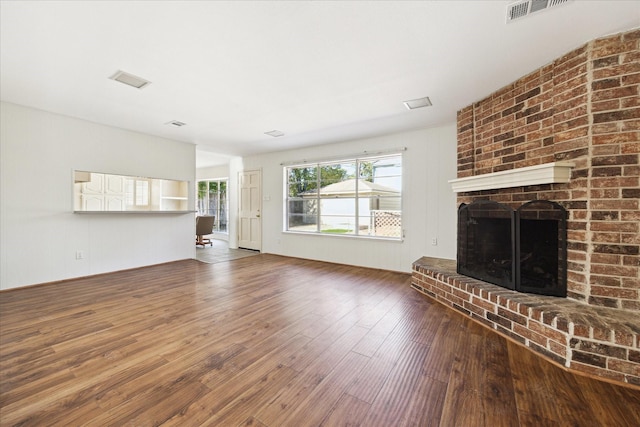 unfurnished living room featuring hardwood / wood-style floors and a fireplace