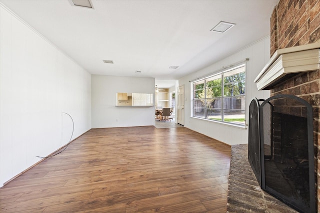 unfurnished living room with a fireplace and wood-type flooring