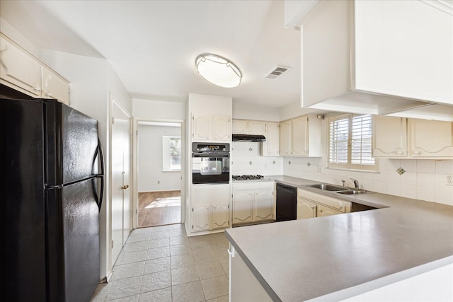 kitchen featuring black appliances, backsplash, kitchen peninsula, and sink