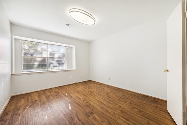 spare room with dark hardwood / wood-style floors