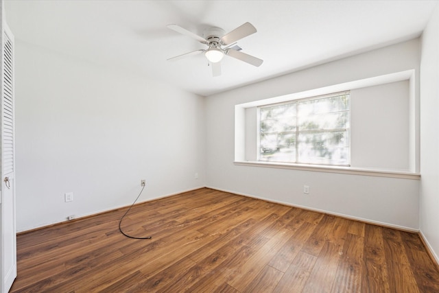 unfurnished room with ceiling fan and dark hardwood / wood-style flooring