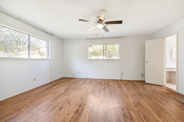 empty room featuring ceiling fan and light hardwood / wood-style flooring