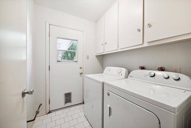 laundry room featuring cabinets, separate washer and dryer, and light tile patterned flooring