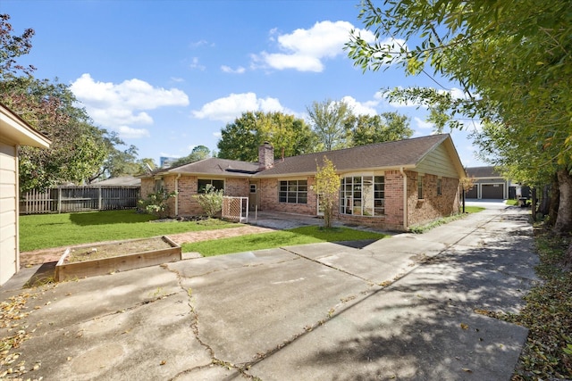 rear view of house featuring a yard