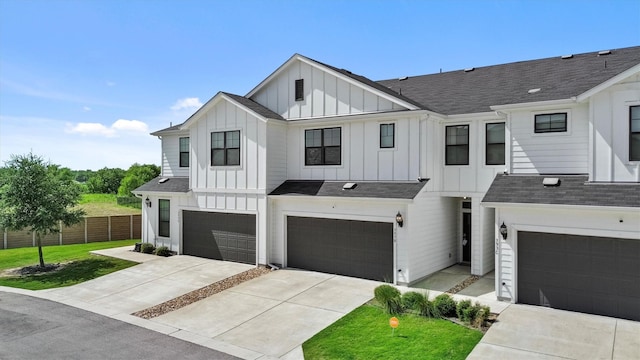 modern farmhouse style home with a front lawn and a garage