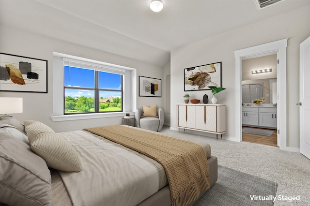 bedroom featuring carpet and ensuite bath