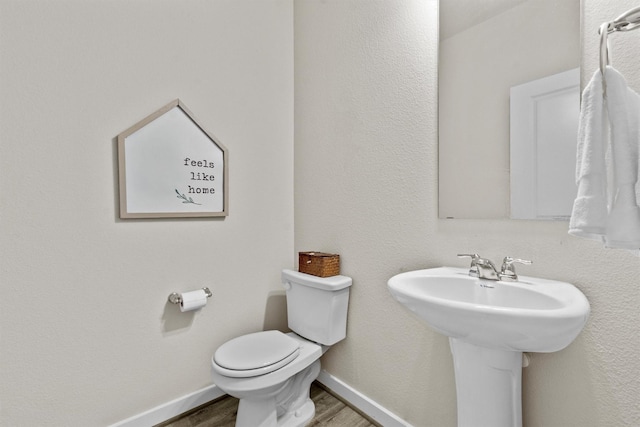 bathroom with sink, wood-type flooring, and toilet