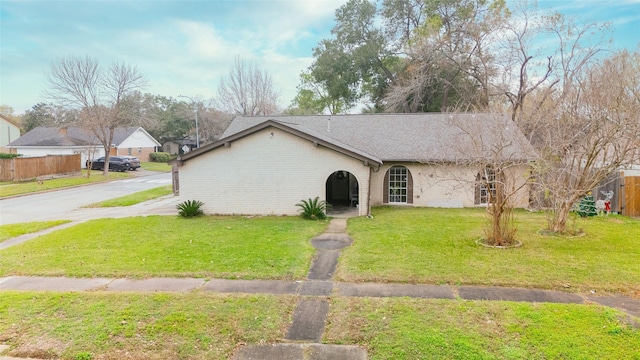 single story home featuring a front yard